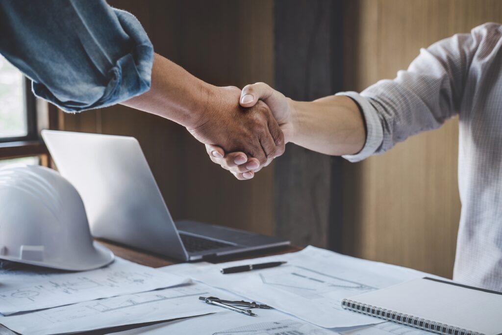 Two people shaking hands to close a deal