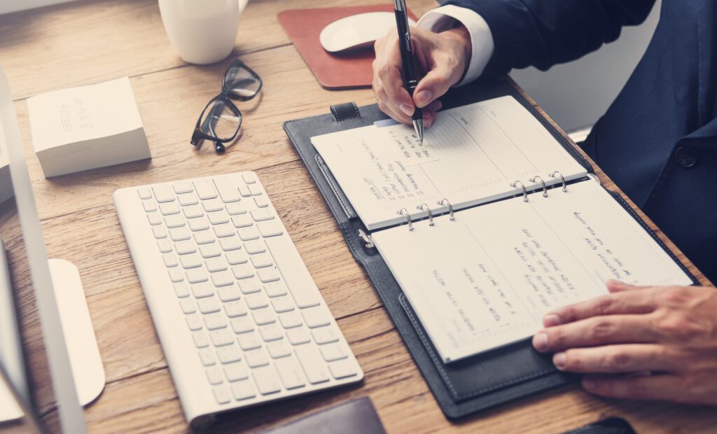 Man writing down his schedule