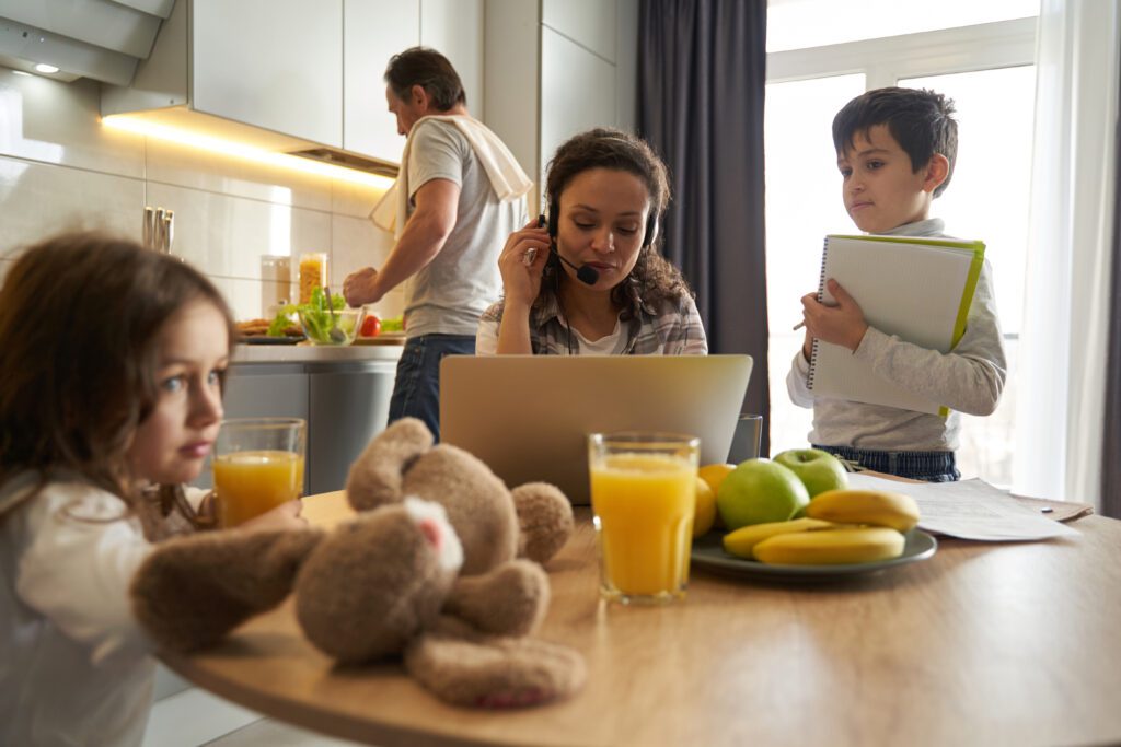 woman in a virtual meeting with kids around