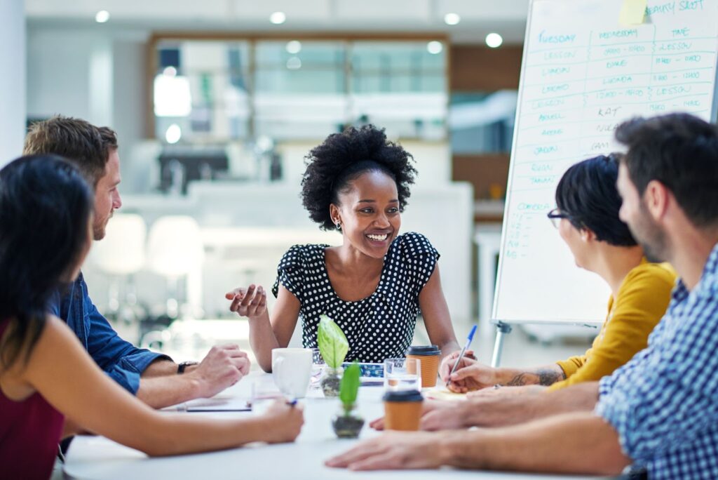 a black woman leading a company meeting