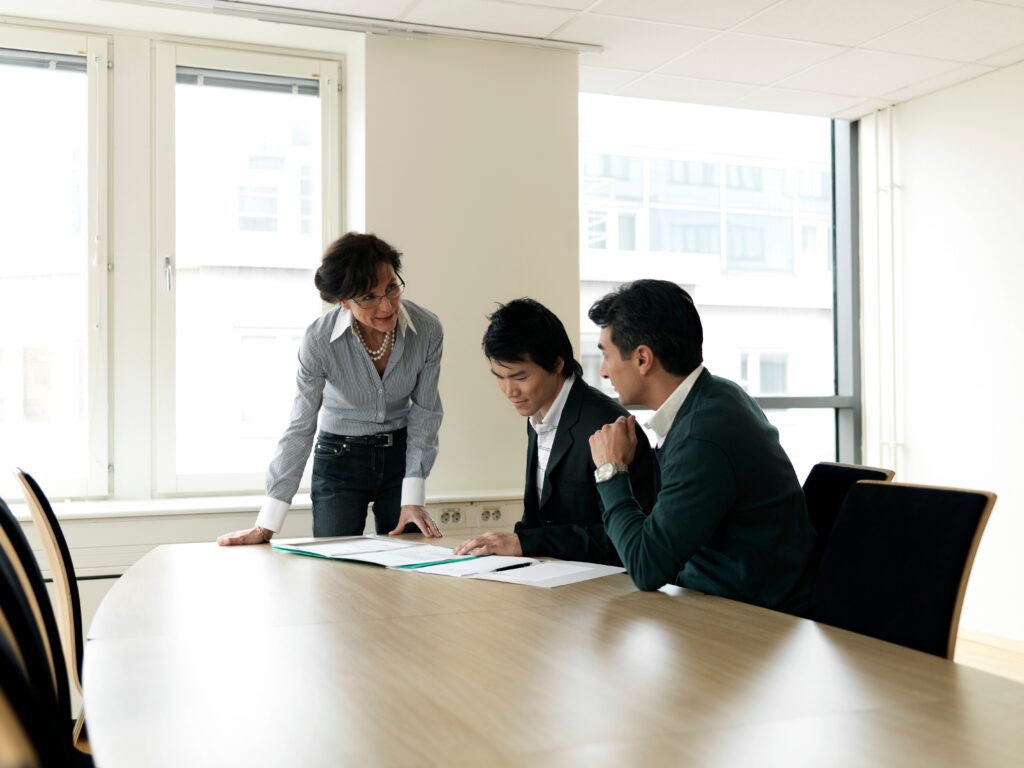 three people in a meeting